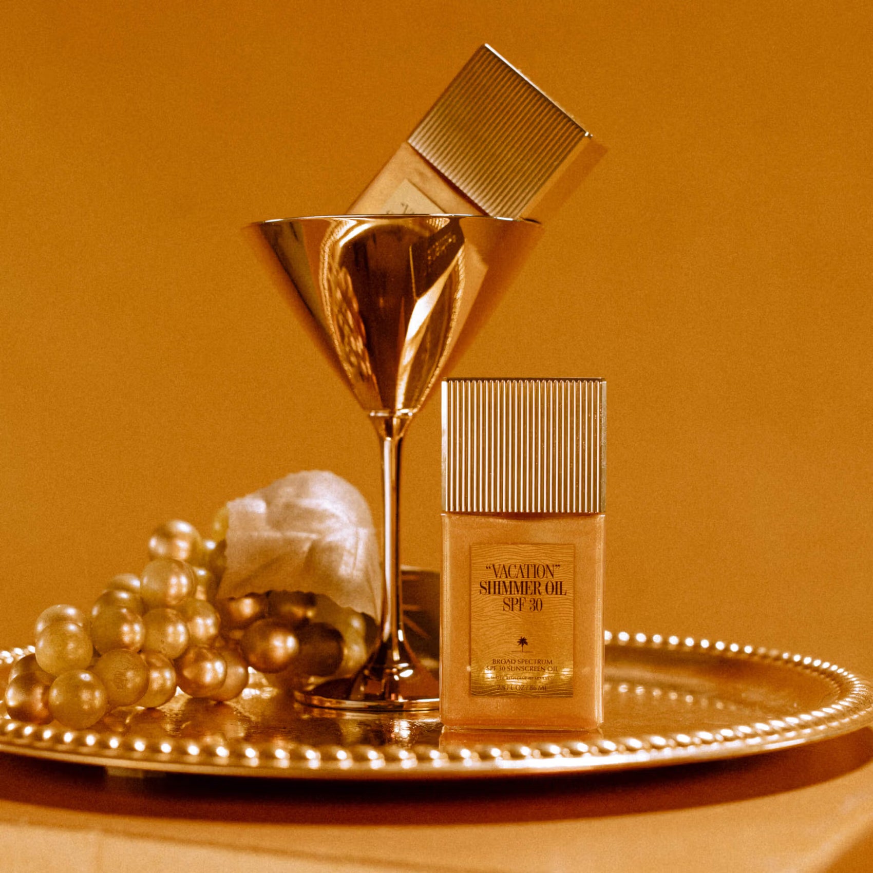 Vacation Shimmer Oil SPF 30 sunscreen for a luminous summer glow with reef-safe ingredients and lightweight shimmer at The Skyn Distillery Wayzata MN